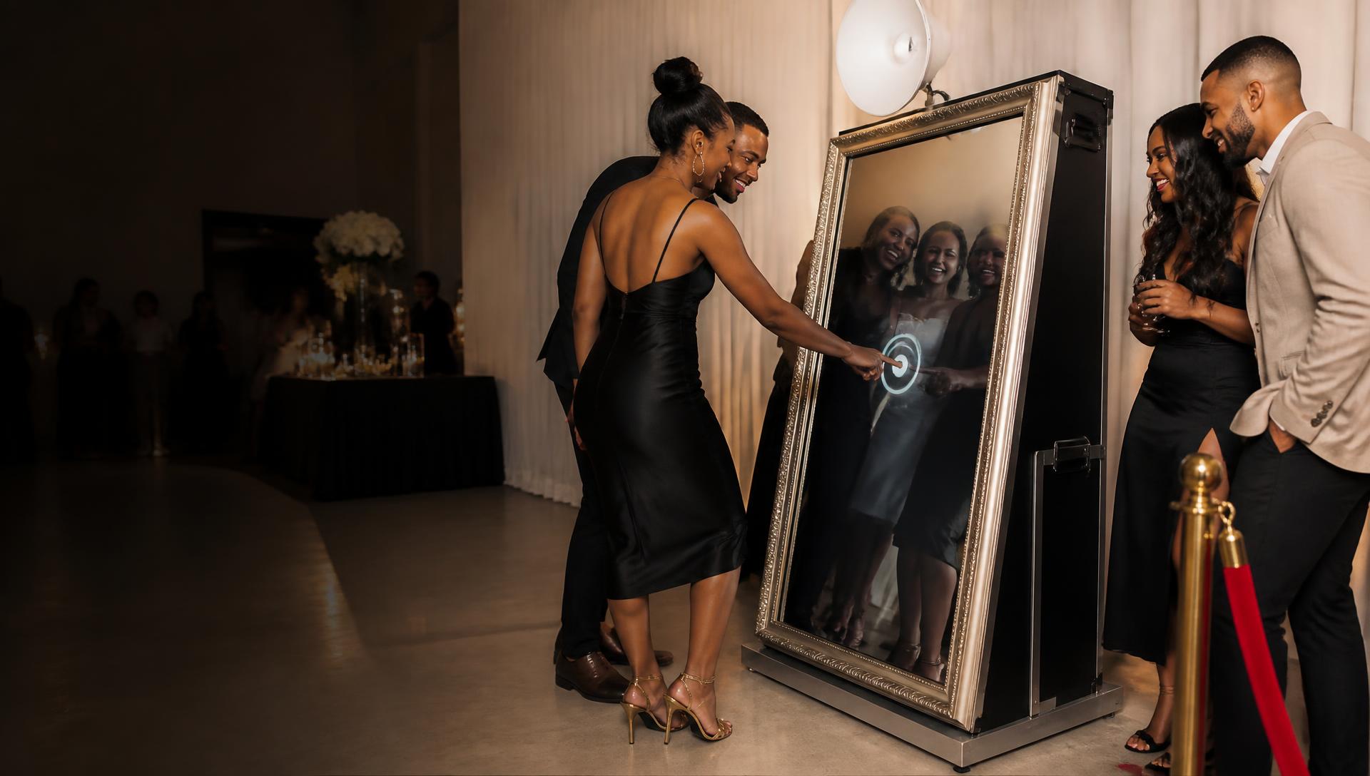 Guests actively using a full-size Magic Mirror photo booth at an elegant Atlanta event